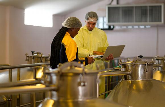 floor manager and worker talking in wine warehouse
